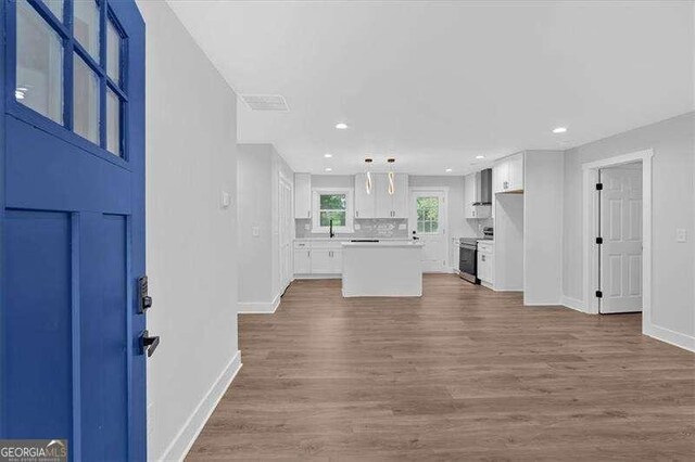 2326 Brackett St SW, Marietta, GA 30060 - unfurnished living room with baseboards, wood finished floors, and recessed lighting