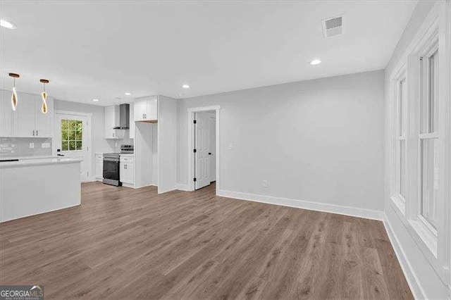 2326 Brackett St SW, Marietta, GA 30060 - unfurnished living room featuring wood finished floors, baseboards, and recessed lighting