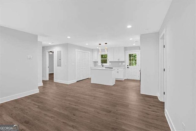 2326 Brackett St SW, Marietta, GA 30060 - unfurnished living room featuring baseboards, dark wood finished floors, recessed lighting, and a sink