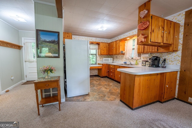 115 Jin Ln, Franklin, NC 28734 - kitchen featuring white appliances, brown cabinetry, light carpet, light countertops, and a peninsula