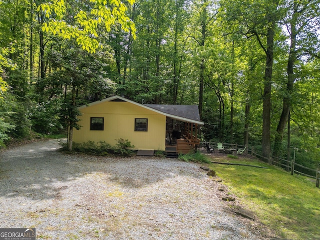 115 Jin Ln, Franklin, NC 28734 - view of front facade with gravel driveway, a forest view, and a deck