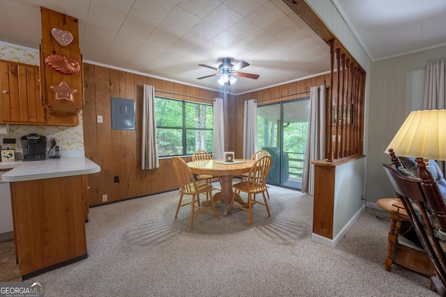 115 Jin Ln, Franklin, NC 28734 - dining space with ornamental molding, light carpet, ceiling fan, baseboards, and wood walls