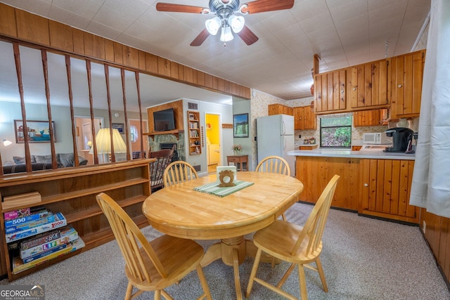 115 Jin Ln, Franklin, NC 28734 - dining area featuring a ceiling fan, light colored carpet, and a fireplace