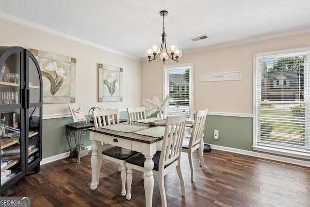 75 Hunters Ct, Dallas, GA 30157 - dining space with a chandelier, dark wood-style flooring, a textured ceiling, baseboards, and ornamental molding
