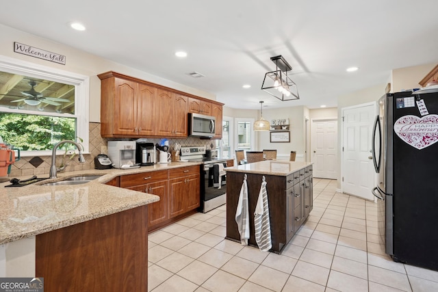 75 Hunters Ct, Dallas, GA 30157 - kitchen with stainless steel appliances, a sink, tasteful backsplash, light stone counters, and decorative light fixtures