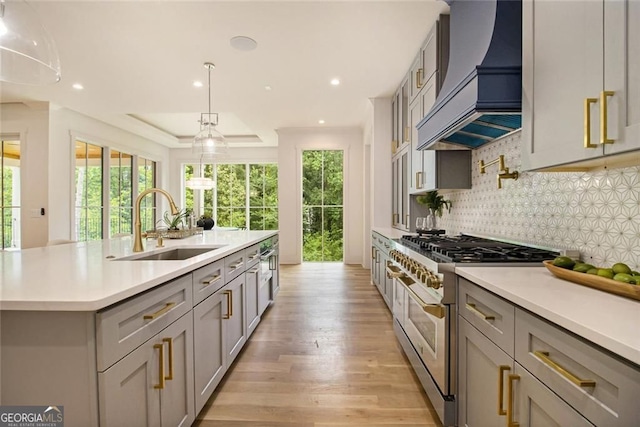 4757 Lake Forrest Dr NW, Atlanta, GA 30342 - kitchen with double oven range, custom exhaust hood, gray cabinets, light countertops, and backsplash