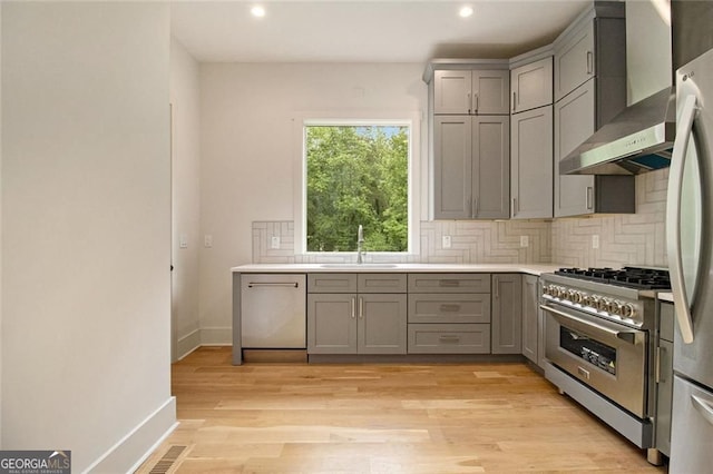 4757 Lake Forrest Dr NW, Atlanta, GA 30342 - kitchen featuring gray cabinetry, appliances with stainless steel finishes, wall chimney exhaust hood, a sink, and recessed lighting