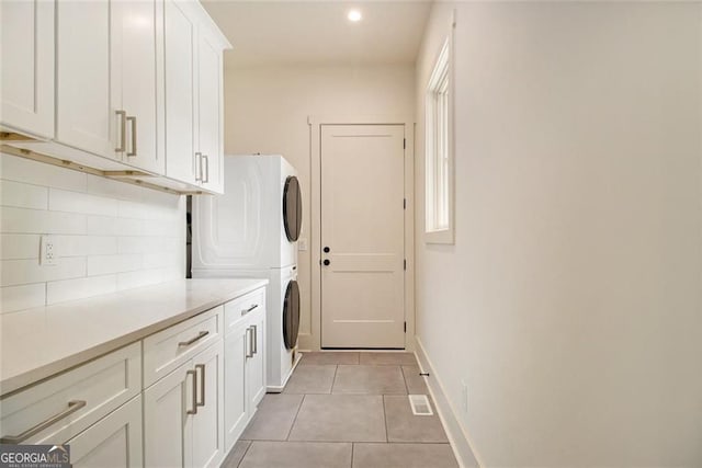 4757 Lake Forrest Dr NW, Atlanta, GA 30342 - washroom with stacked washer and clothes dryer, cabinet space, light tile patterned flooring, baseboards, and recessed lighting