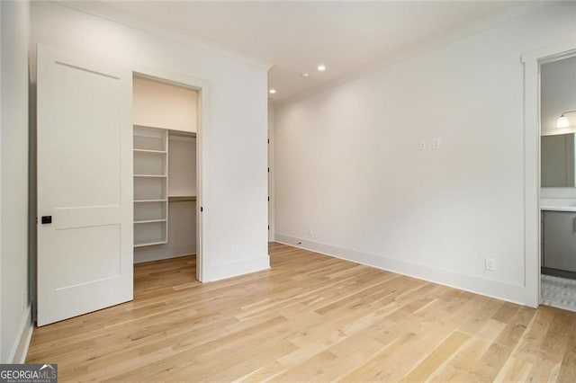 4757 Lake Forrest Dr NW, Atlanta, GA 30342 - unfurnished bedroom featuring a spacious closet, wood finished floors, recessed lighting, ensuite bath, and baseboards