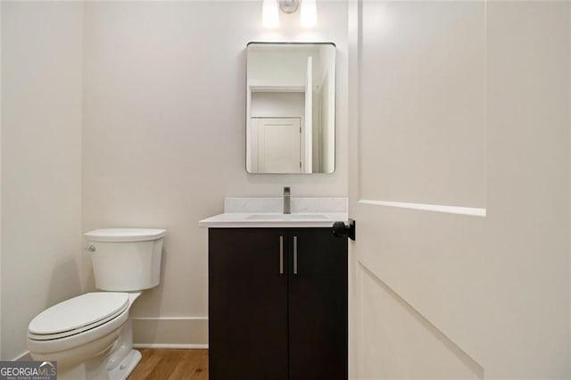 4757 Lake Forrest Dr NW, Atlanta, GA 30342 - bathroom featuring vanity, toilet, baseboards, and wood finished floors