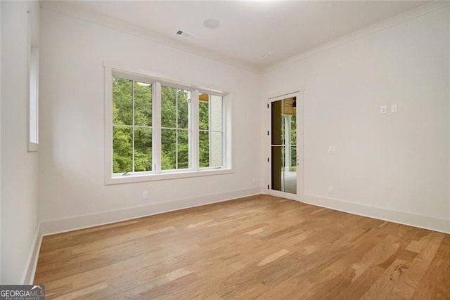 4757 Lake Forrest Dr NW, Atlanta, GA 30342 - empty room featuring healthy amount of natural light, baseboards, light wood-type flooring, and crown molding