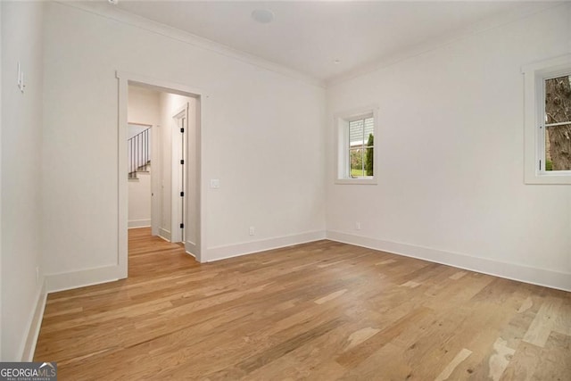 4757 Lake Forrest Dr NW, Atlanta, GA 30342 - spare room featuring crown molding, light wood-style floors, and baseboards