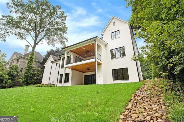 4757 Lake Forrest Dr NW, Atlanta, GA 30342 - rear view of house with ceiling fan, a yard, a balcony, and stucco siding