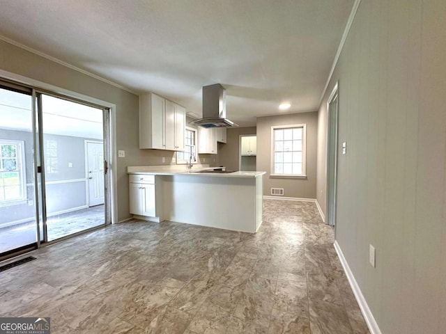 120 Watson Dr, Athens, GA 30605 - kitchen featuring island exhaust hood, white cabinetry, crown molding, baseboards, and a sink