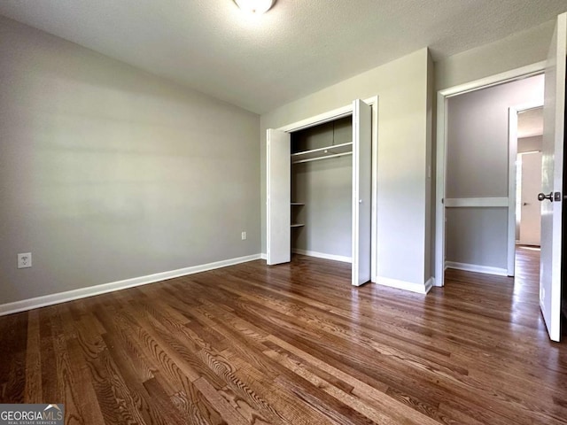120 Watson Dr, Athens, GA 30605 - unfurnished bedroom featuring dark wood finished floors, baseboards, a closet, and lofted ceiling