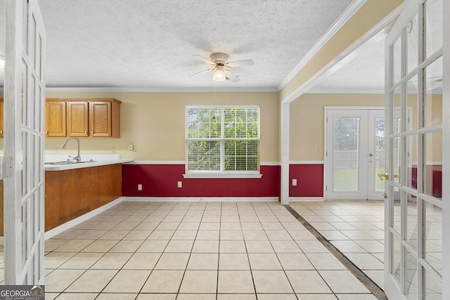2881 Bridle Creek Dr SW, Conyers, GA 30094 - kitchen featuring french doors, a ceiling fan, light countertops, brown cabinetry, and a textured ceiling