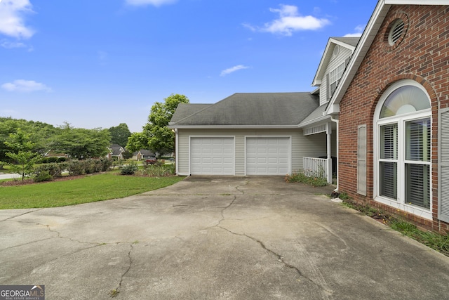 2881 Bridle Creek Dr SW, Conyers, GA 30094 - view of property exterior with concrete driveway, an attached garage, brick siding, a lawn, and a shingled roof