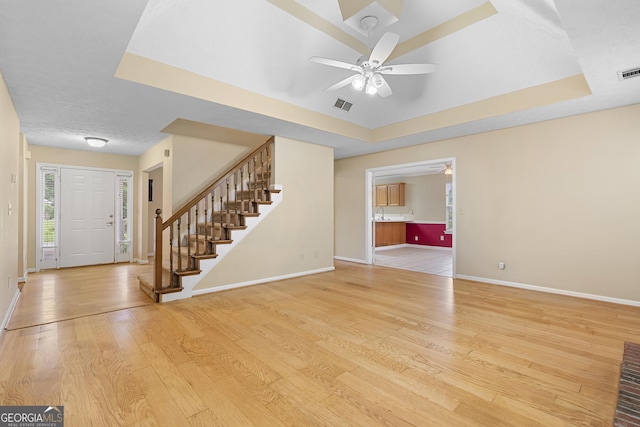 2881 Bridle Creek Dr SW, Conyers, GA 30094 - entrance foyer featuring a raised ceiling, stairway, a ceiling fan, and light wood-style flooring