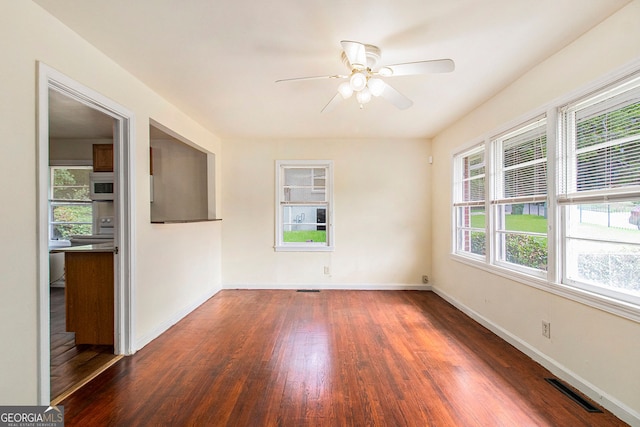 2329 Polar Rock Ave SW, Atlanta, GA 30315 - spare room featuring dark wood-style flooring, ceiling fan, and baseboards