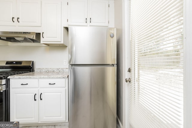 1381 Benteen Way SE, Atlanta, GA 30315 - kitchen featuring stainless steel appliances, under cabinet range hood, white cabinets, and light stone countertops