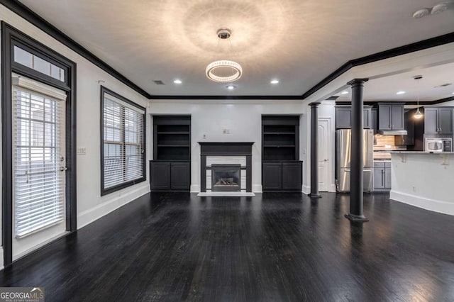 2767 Durham Dr NE, Atlanta, GA 30319 - unfurnished living room with decorative columns, baseboards, wood finished floors, ornamental molding, and a glass covered fireplace