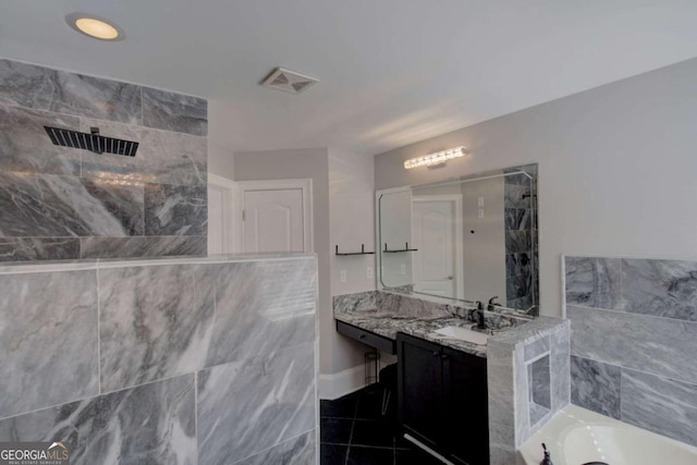 2767 Durham Dr NE, Atlanta, GA 30319 - bathroom with a garden tub, vanity, a tile shower, tile patterned floors, and baseboards
