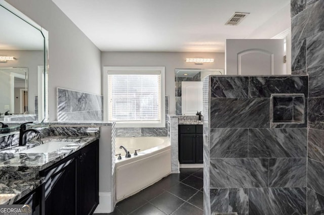 2767 Durham Dr NE, Atlanta, GA 30319 - bathroom featuring a bath, two vanities, tiled shower, and tile patterned flooring