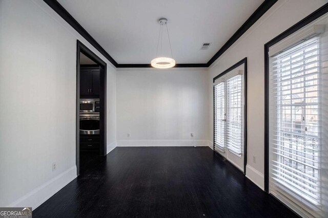 2767 Durham Dr NE, Atlanta, GA 30319 - unfurnished dining area with dark wood finished floors, baseboards, and ornamental molding