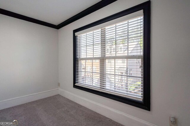 2767 Durham Dr NE, Atlanta, GA 30319 - empty room with healthy amount of natural light, carpet flooring, ornamental molding, and baseboards