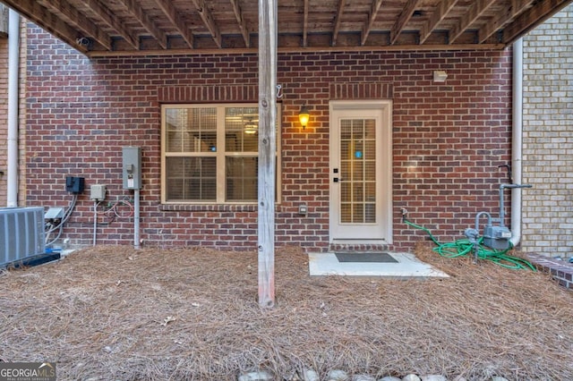 2767 Durham Dr NE, Atlanta, GA 30319 - view of exterior entry with brick siding and central air condition unit