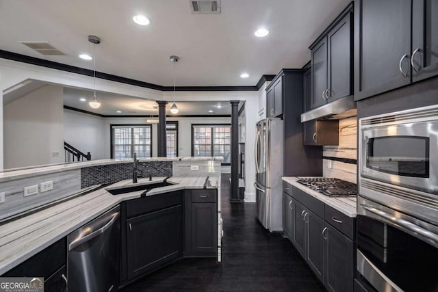 2767 Durham Dr NE, Atlanta, GA 30319 - kitchen featuring stainless steel appliances, ornate columns, tasteful backsplash, ornamental molding, and dark wood finished floors