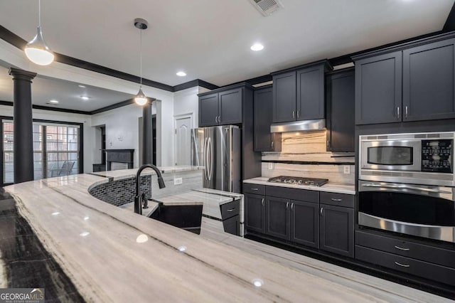2767 Durham Dr NE, Atlanta, GA 30319 - kitchen featuring stainless steel appliances, a sink, under cabinet range hood, hanging light fixtures, and light stone countertops