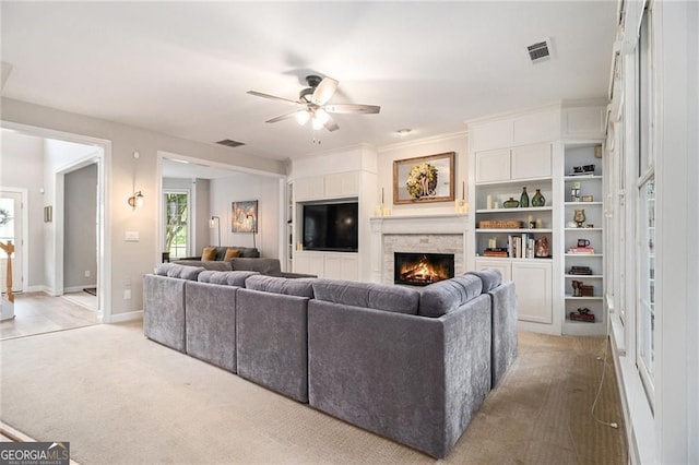 525 Arbor Creek Ct, Roswell, GA 30076 - living area with ceiling fan, a warm lit fireplace, light colored carpet, baseboards, and ornamental molding