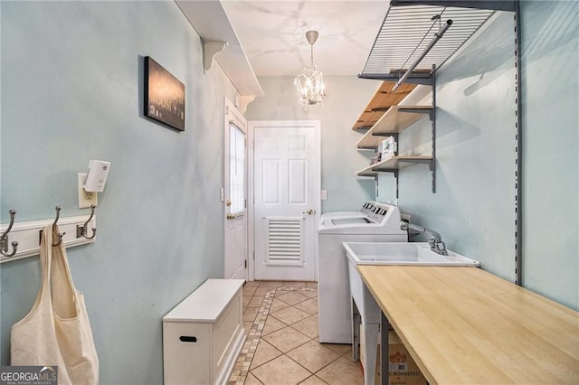 525 Arbor Creek Ct, Roswell, GA 30076 - laundry room with washer and dryer, light tile patterned flooring, and a chandelier