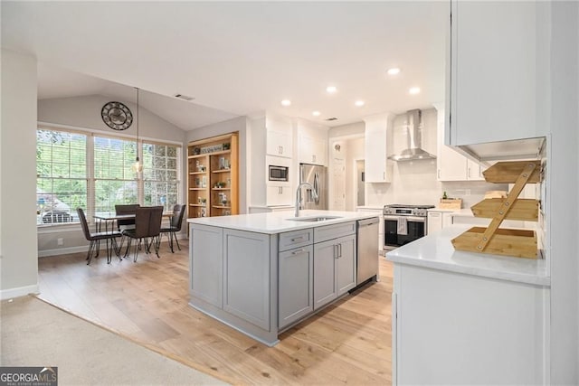 525 Arbor Creek Ct, Roswell, GA 30076 - kitchen featuring wall chimney exhaust hood, appliances with stainless steel finishes, gray cabinets, light wood-style flooring, and light countertops