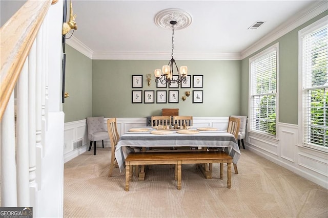 525 Arbor Creek Ct, Roswell, GA 30076 - dining room featuring light carpet, a chandelier, a decorative wall, crown molding, and a wainscoted wall