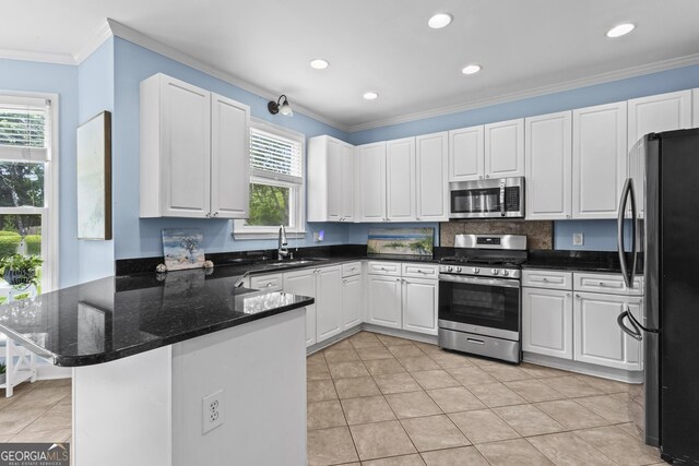 4365 Wicklow Ct, Suwanee, GA 30024 - kitchen with appliances with stainless steel finishes, a peninsula, ornamental molding, white cabinetry, and recessed lighting