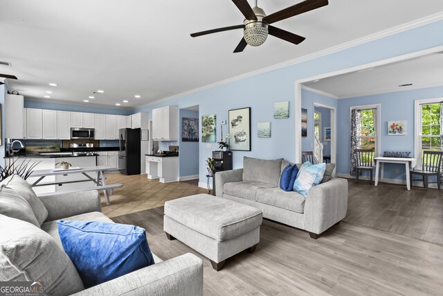 4365 Wicklow Ct, Suwanee, GA 30024 - living area featuring crown molding, ceiling fan, baseboards, light wood-type flooring, and recessed lighting