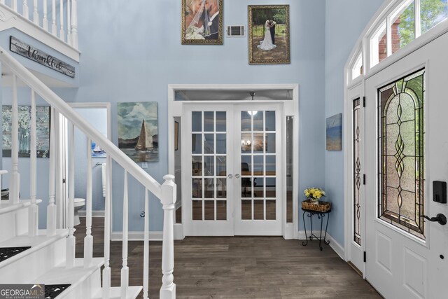 4365 Wicklow Ct, Suwanee, GA 30024 - foyer with french doors, a towering ceiling, wood finished floors, stairway, and baseboards