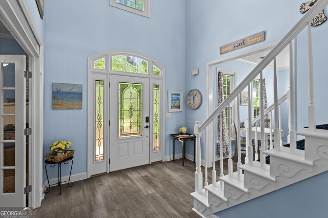 4365 Wicklow Ct, Suwanee, GA 30024 - entrance foyer featuring plenty of natural light, wood finished floors, stairway, baseboards, and a towering ceiling