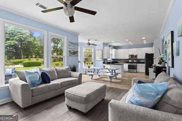 4365 Wicklow Ct, Suwanee, GA 30024 - living area featuring ceiling fan, ornamental molding, recessed lighting, and light wood-style flooring