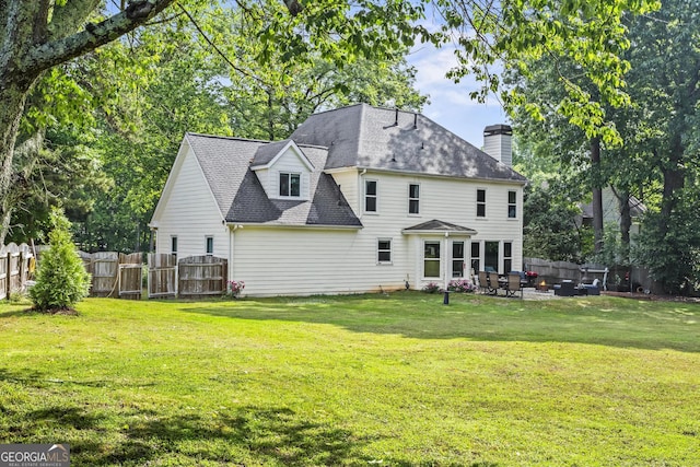 4365 Wicklow Ct, Suwanee, GA 30024 - rear view of house featuring a patio area, a chimney, roof with shingles, and outdoor lounge area