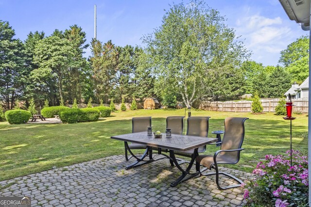 4365 Wicklow Ct, Suwanee, GA 30024 - view of patio featuring outdoor dining space and view of wooded area