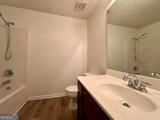 234 Silver Arrow Cir, Austell, GA 30168 - bathroom featuring wood finished floors, shower / washtub combination, toilet, a textured ceiling, and vanity