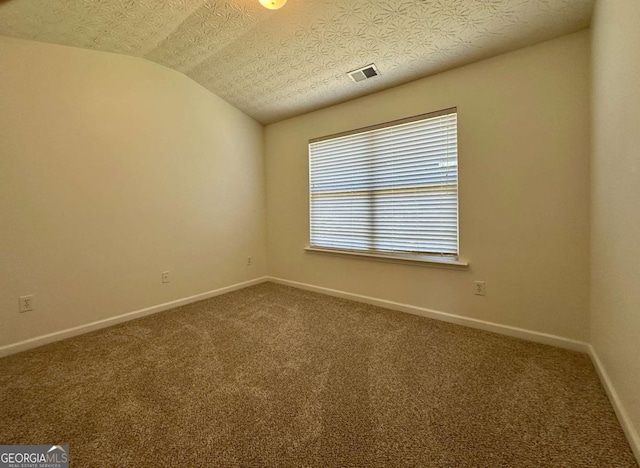 234 Silver Arrow Cir, Austell, GA 30168 - spare room with carpet floors, baseboards, lofted ceiling, and a textured ceiling