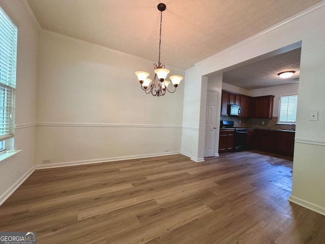234 Silver Arrow Cir, Austell, GA 30168 - unfurnished dining area with dark wood-type flooring, a chandelier, crown molding, baseboards, and a sink