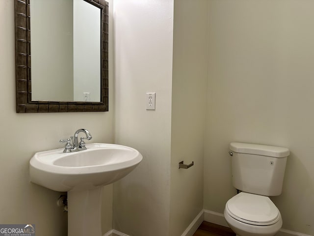234 Silver Arrow Cir, Austell, GA 30168 - bathroom with baseboards, toilet, and a sink
