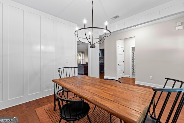 19 E Murphy St, Newnan, GA 30263 - dining room featuring a chandelier, wood finished floors, and baseboards