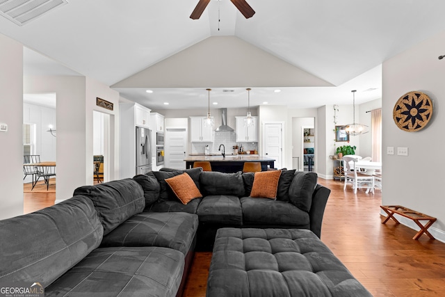 19 E Murphy St, Newnan, GA 30263 - living room with a ceiling fan, lofted ceiling, wood finished floors, a chandelier, and recessed lighting