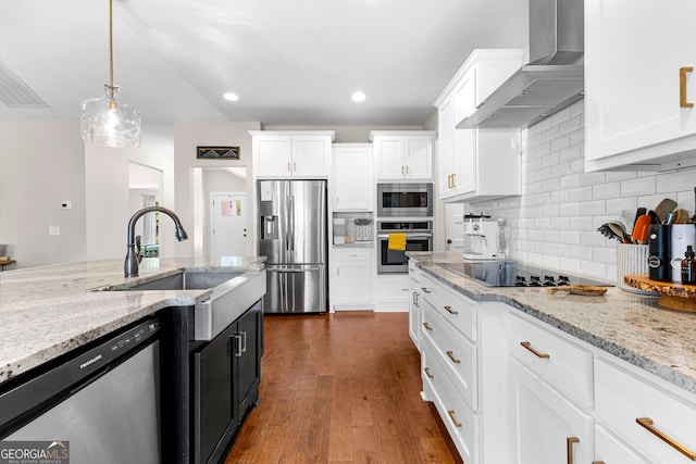 19 E Murphy St, Newnan, GA 30263 - kitchen with appliances with stainless steel finishes, wall chimney range hood, a sink, white cabinetry, and backsplash